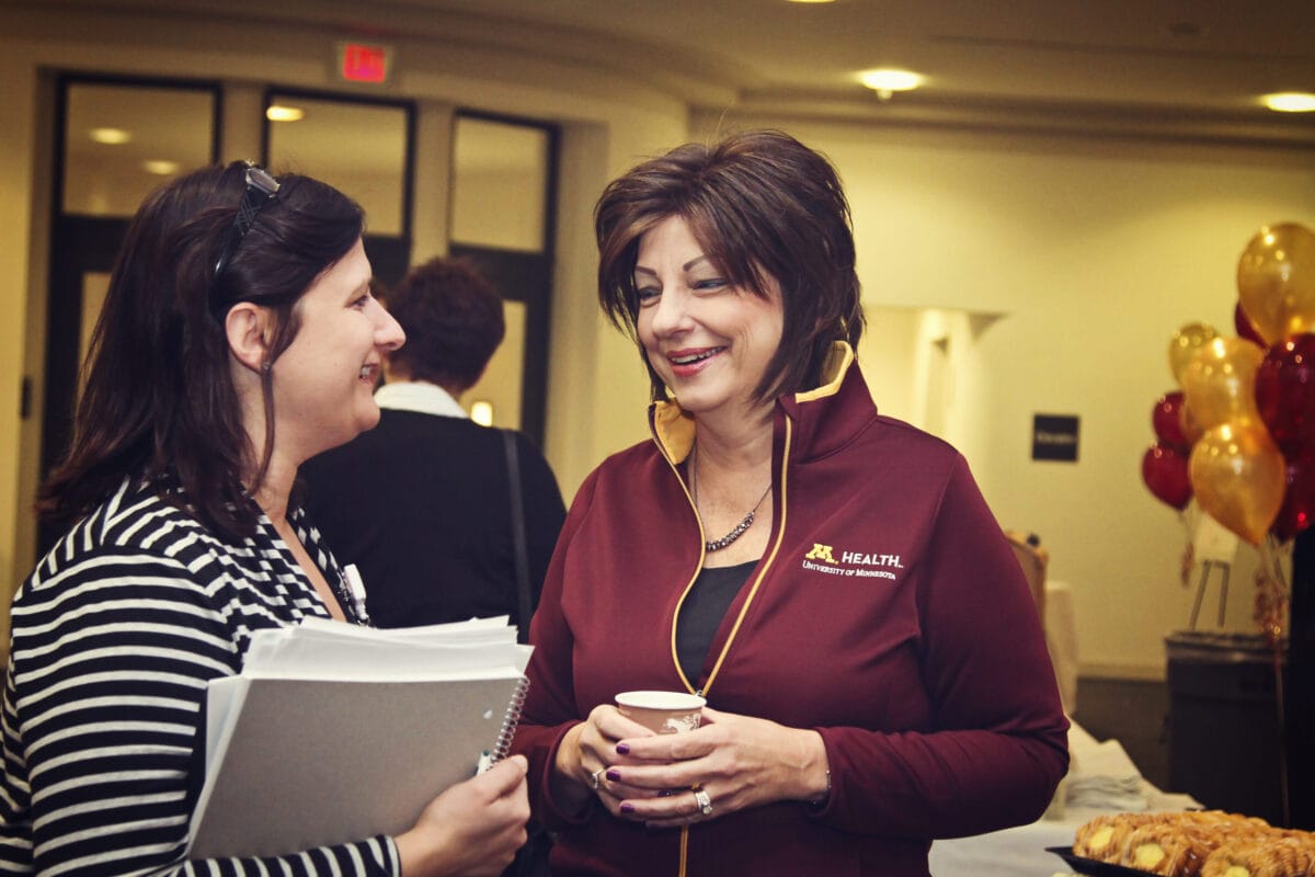 University Of Minnesota Health Leadership talking with team member