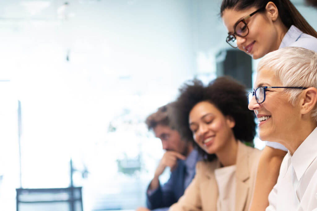 Diverse professionals smiling at a meeting | change management strategies