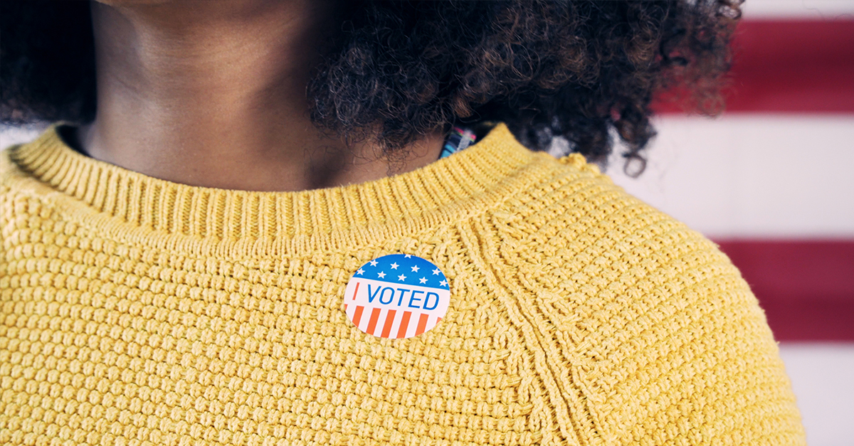 Young Gen Z Voter Wearing Sticker After Voting in Election