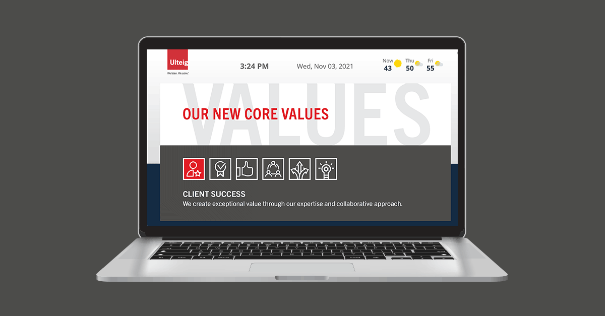 A themed digital desktop background mocked up on a laptop featuring each core value description to promote awareness of new values.