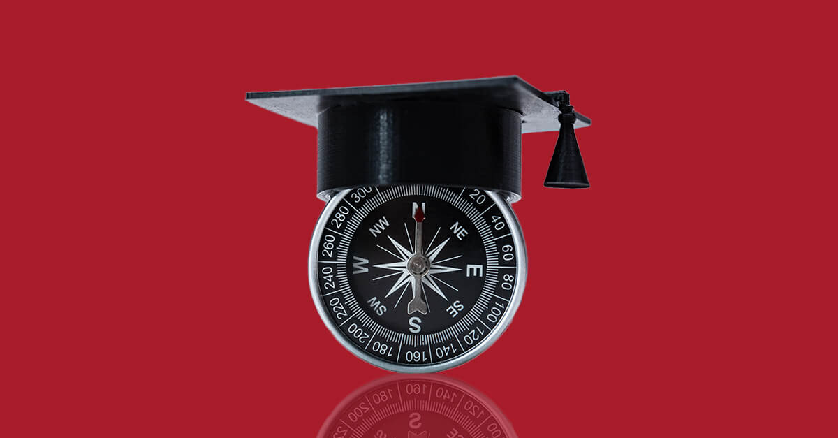 Graduation cap on compass over a red background.