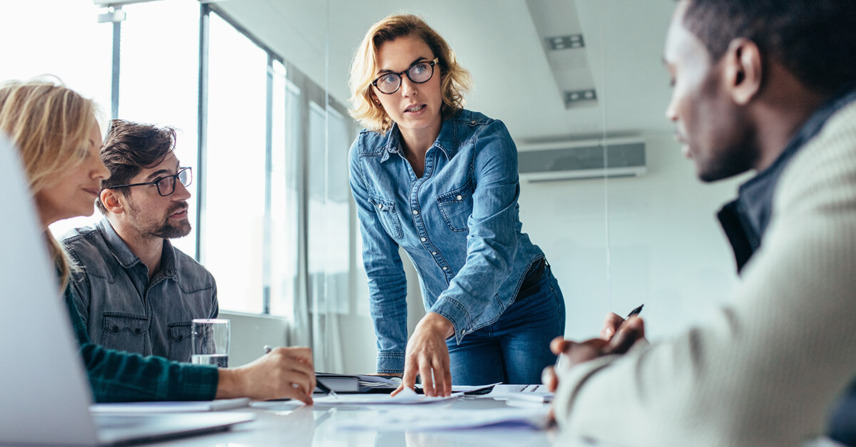 Businesswoman standing and leading business presentation.